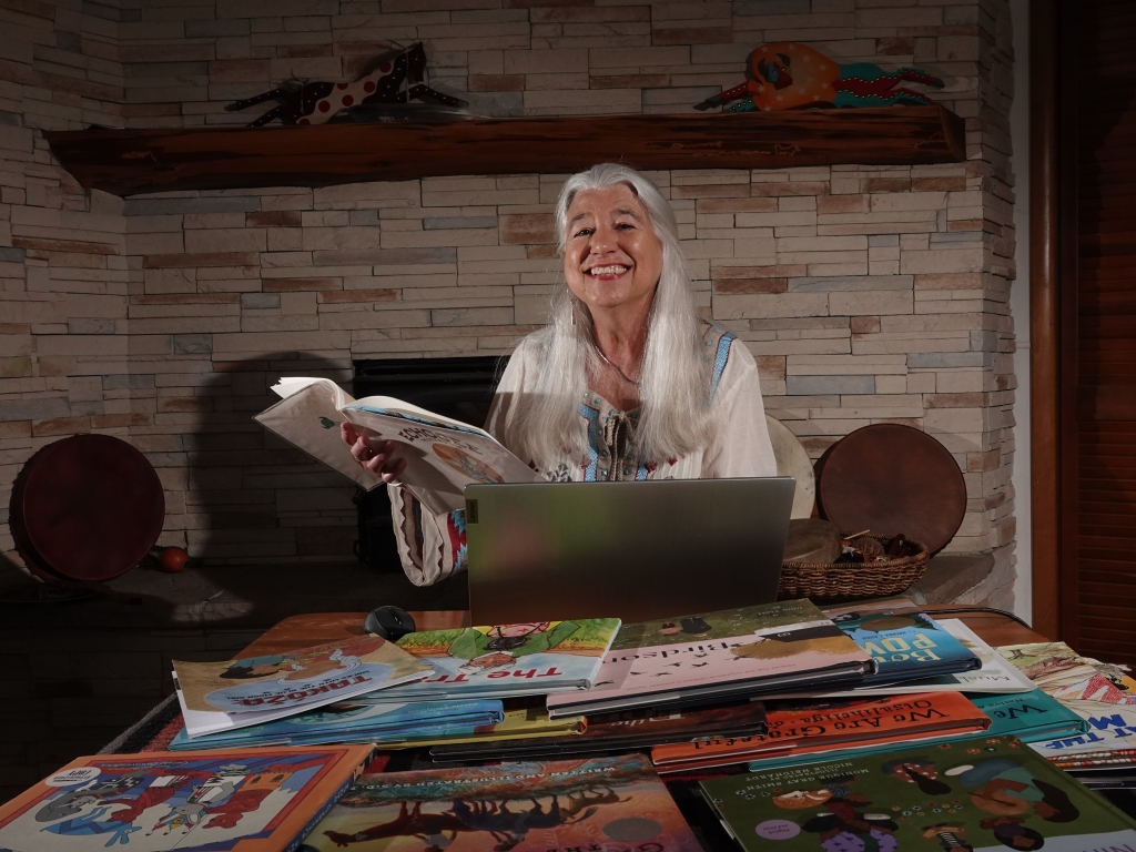 photo of Karen Kitchen smiling, surrounded by picture books